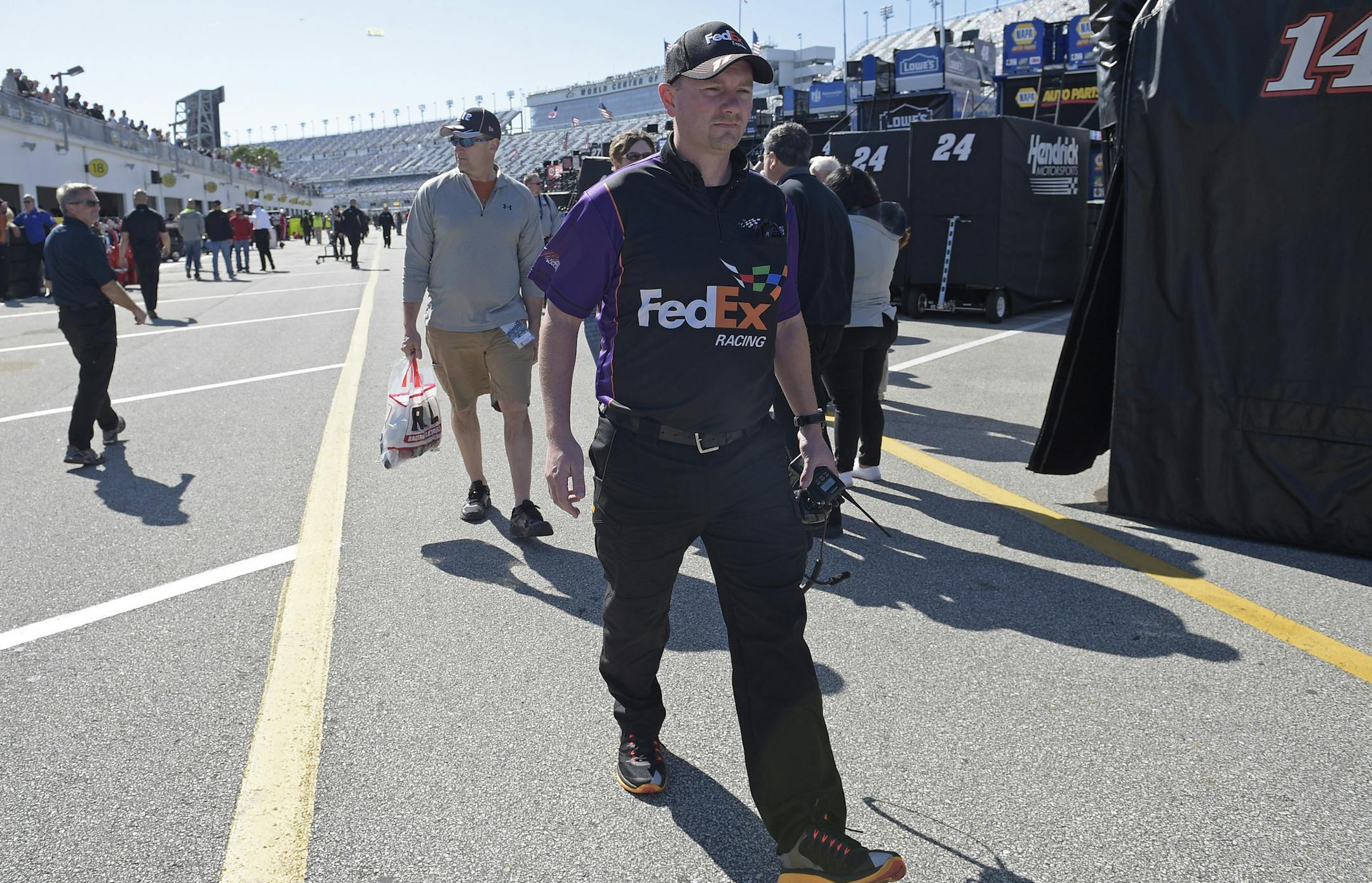 Mike Wheeler, new crew chief for driver Denny Hamlin, walks through the garage area after practice for Sunday's NASCAR Daytona 500 Sprint Cup series auto race at Daytona International Speedway in Daytona Beach, Fla., Thursday, Feb. 18, 2016. (AP Photo/Phelan M. Ebenhack)