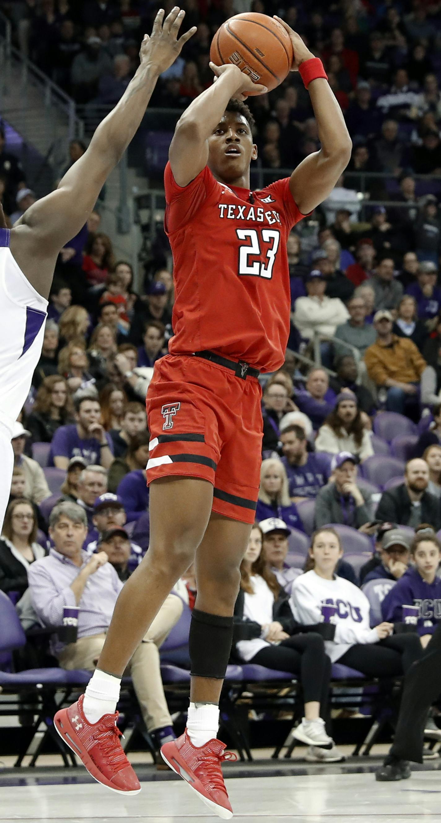 TCU forward Kouat Noi (12) defends as Texas Tech Red Raiders guard Jarrett Culver (23) attempts a 3-point basket in the first half of an NCAA college basketball game in Fort Worth, Texas, Saturday, March 2, 2019. (AP Photo/Tony Gutierrez)