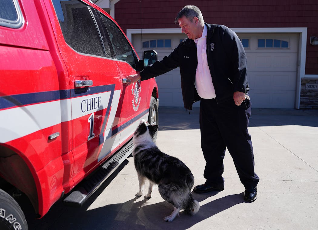Scott Case, the fire chief and board supervisor for Baldwin Township, opens the truck door for his dog at his home that lies in Princeton’s proposed annexation area. He says that annexation would shrink the township tax base and hurt services.