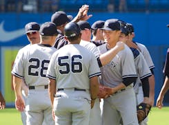 Yankees teammates congratulated pitcher Masahiro Tanaka after his 4-1 victory at Toronto on Saturday.
