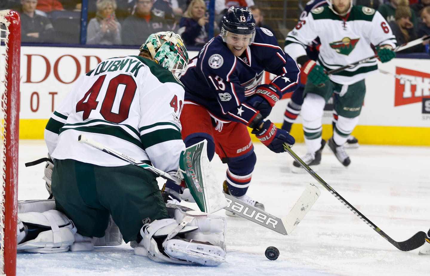 Minnesota Wild's Devan Dubnyk, left, makes a save against Columbus Blue Jackets' Cam Atkinson during the second period of an NHL hockey game Thursday, March 2, 2017, in Columbus, Ohio. (AP Photo/Jay LaPrete)