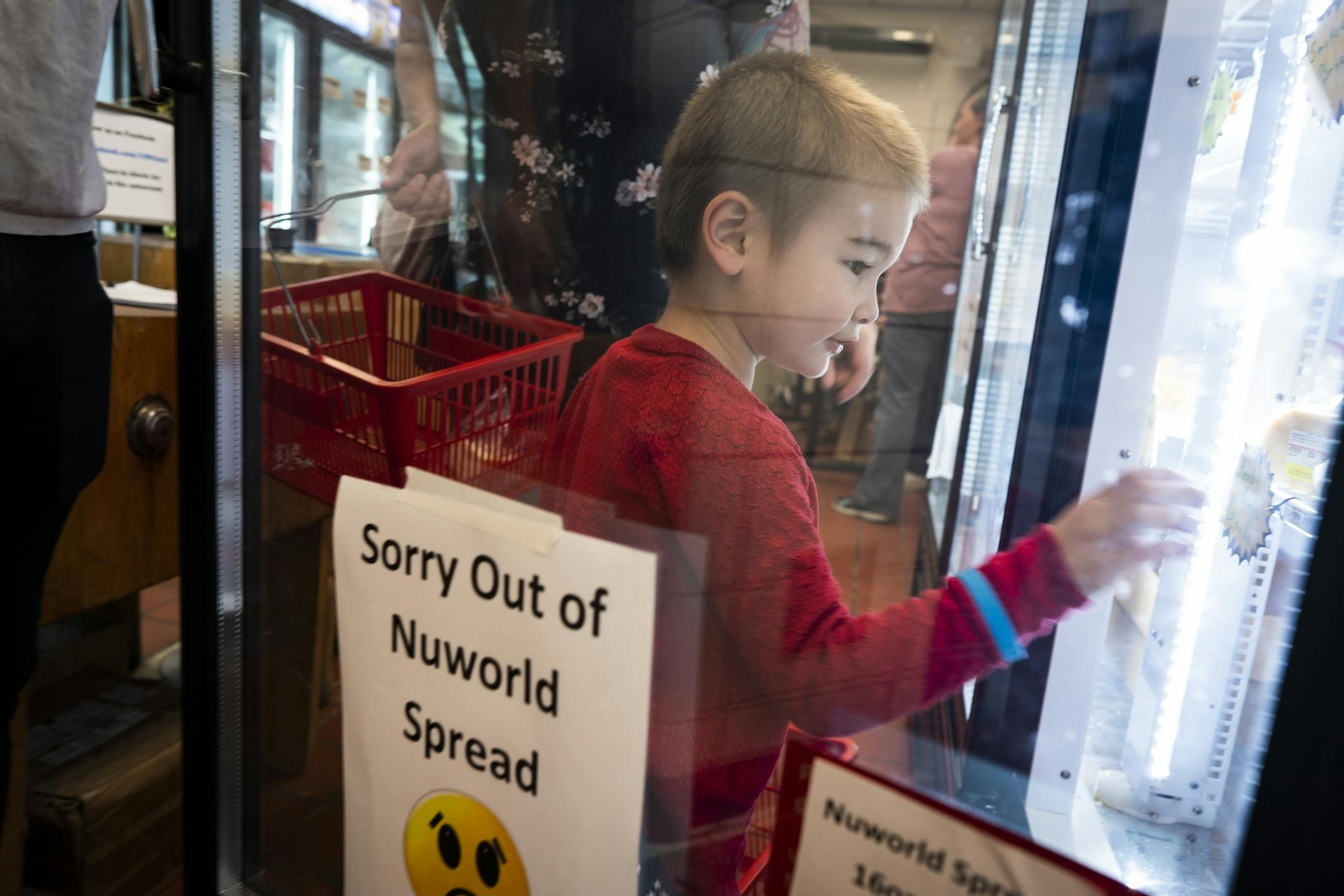 Kacper Berens, 3, picks out some cheese while shopping with mom and dad at the Meat and Dairy salesroom.