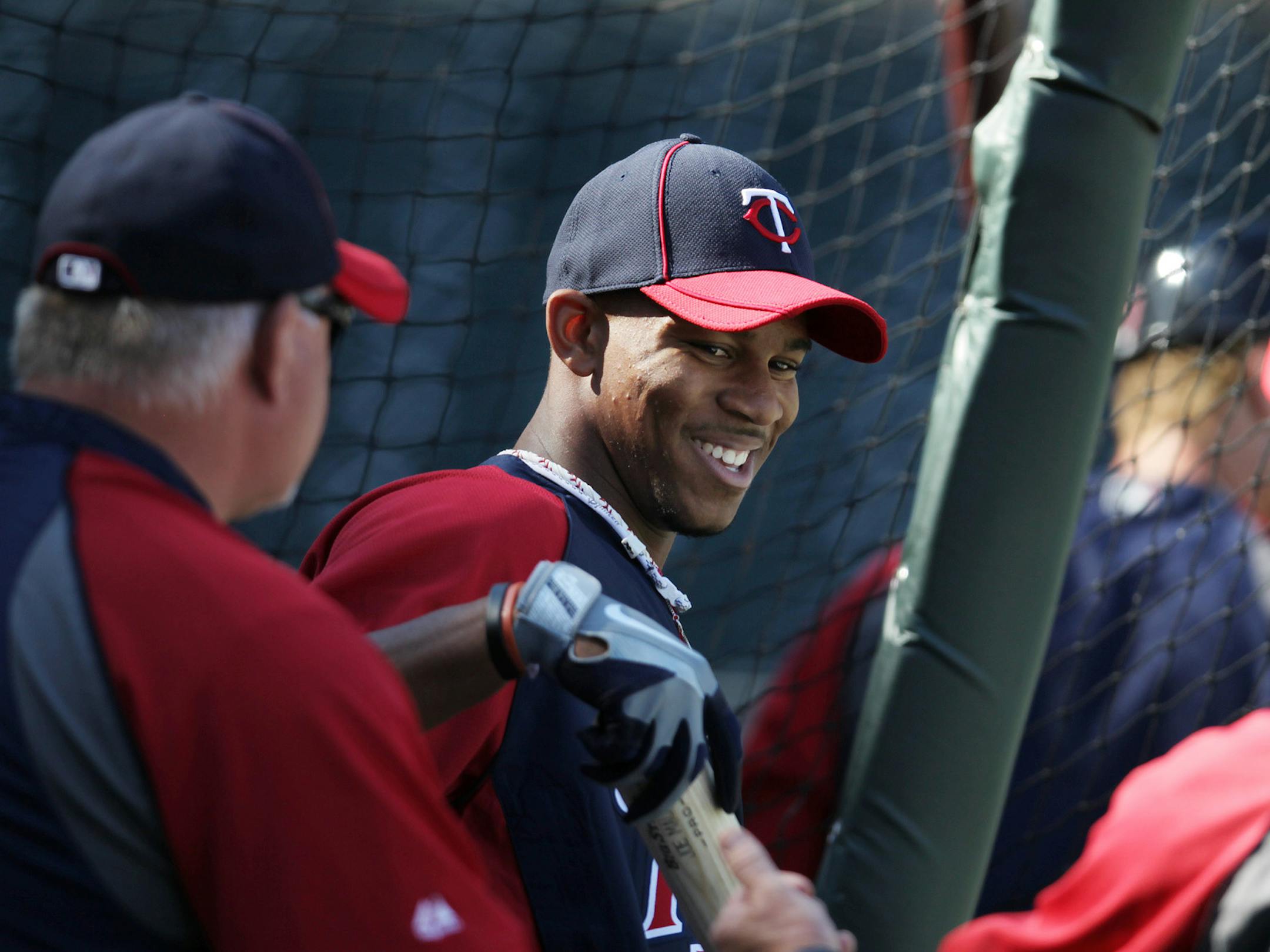 Minnesota Twins first round draft pick Byron Buxton, center, talks with manger Ron Gardenhire and hitting coach Joe Vara during batting practice before an interleague baseball game with the Philadelphia Phillies, Tuesday, June 12, 2012, in Minneapolis.
