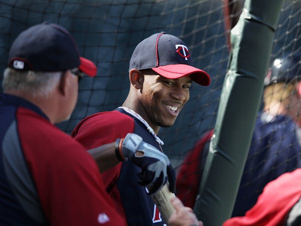 Minnesota Twins first round draft pick Byron Buxton, center, talks with manger Ron Gardenhire and hitting coach Joe Vara during batting practice befor