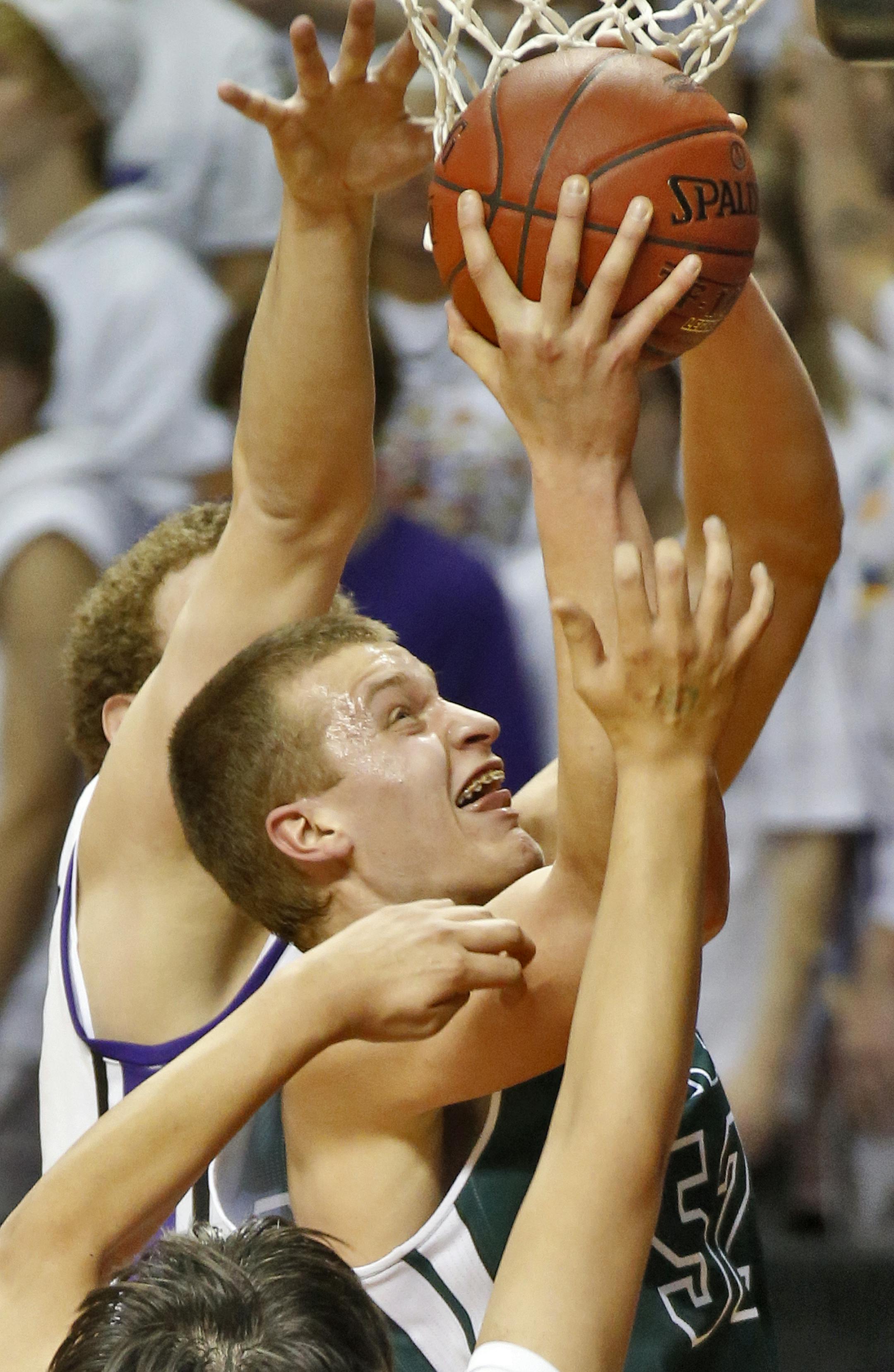 Holy Family'sJustin Dahl (52) had his shot contested by the Cloquet defense. ] Boys Basketball State Tournament. Class 3A Cloquet vs. Holy Family Catholic (MARLIN LEVISON/STARTRIBUNE(mlevison@startribune.com)