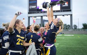 Mahtomedi players celebrate their flag football state championship Monday at TCO Stadium.