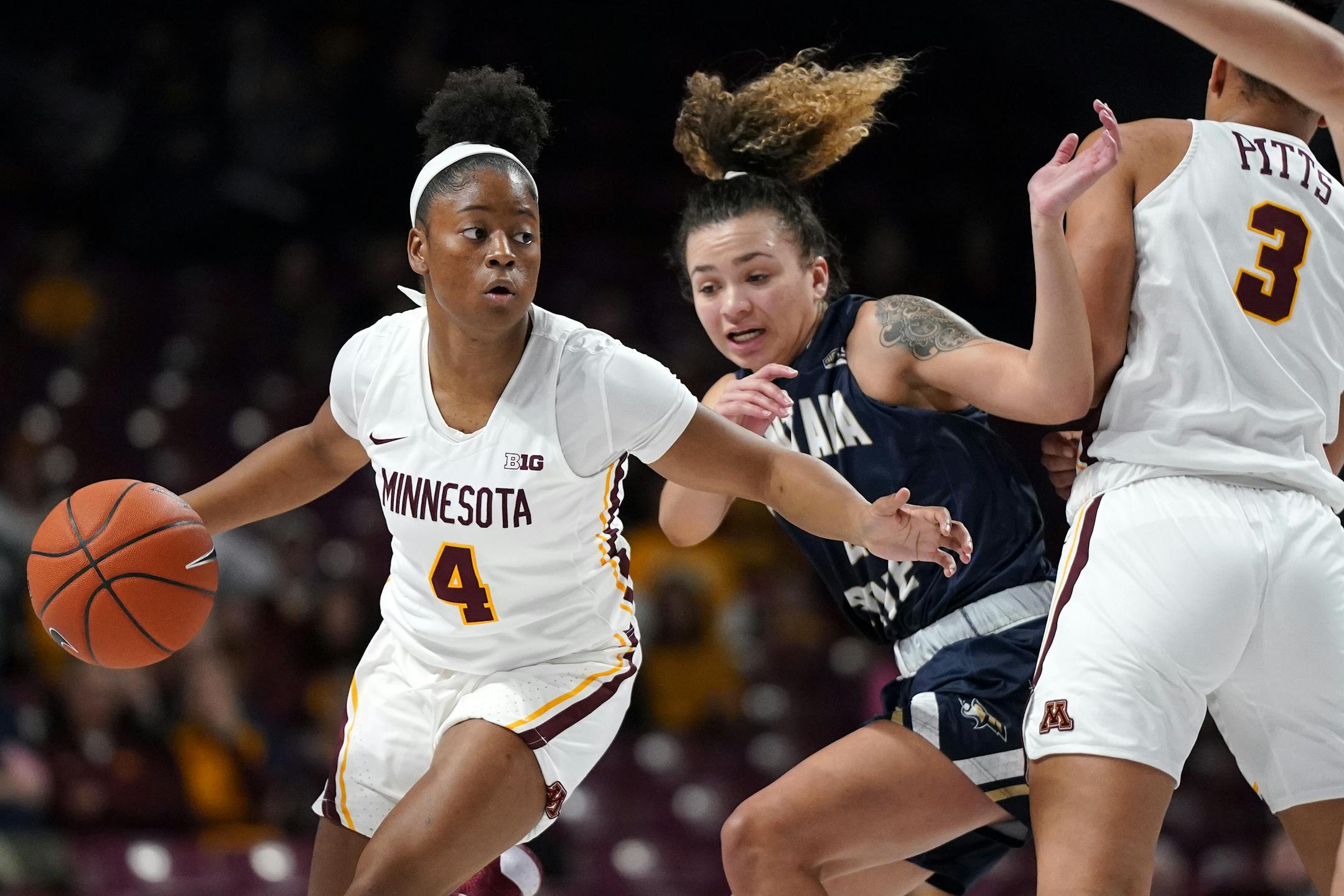 Gophers guard Jasmine Powell moved the ball around Bobcats guard Darian White (2) in the first half.