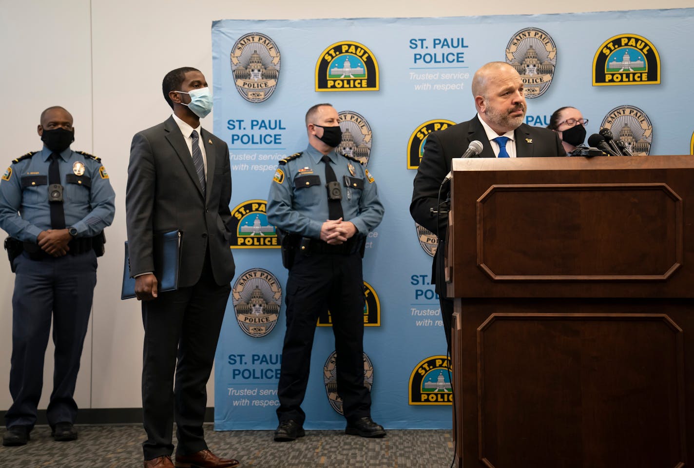 St. Paul Police Chief Todd Axtell, Mayor Melvin Carter and other officers stood at the podium as body camera footage played at a news conference Tuesday about a weekend shooting by a police officer.