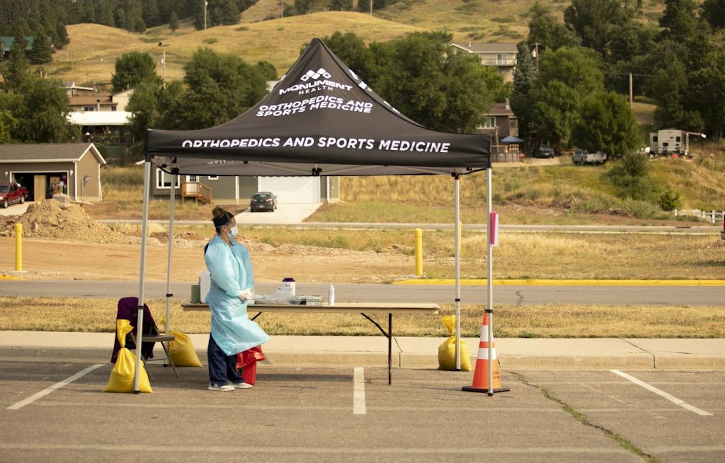 A nurse waits for people to arrive to be tested for COVID-19 in Sturgis, S.D., Monday, Aug. 24, 2020. The hundreds of thousands of bikers who attended the Sturgis Motorcycle Rally may have departed western South Dakota, but public health departments in multiple states are trying to measure how much and how quickly the coronavirus spread in bars, tattoo shops and gatherings before people traveled home to nearly every state in the country.