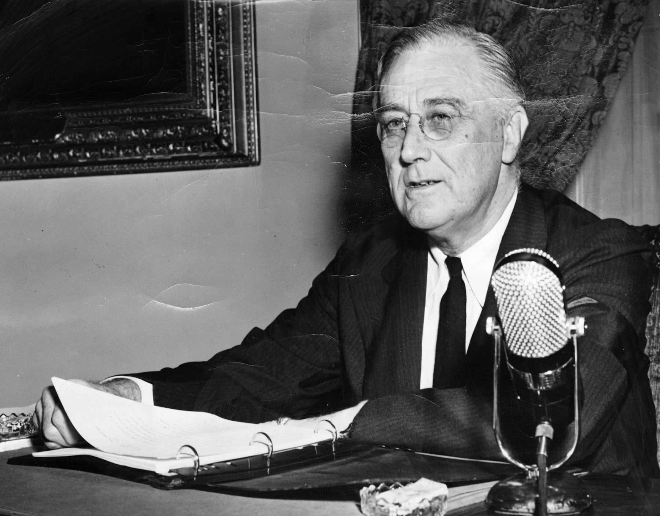 FDR delivers a fireside chat // US president Franklin D. Roosevelt is pictured as he made a nation-wide fireside chat, October 12, 1942, over the radio, during which he said the time has come to draft 18- and 19-year-olds youths for military service. Other highlights of his talk covered manpower, the second front, inflation, production, armchair generals, and the war aim. Photo distributed by Acme Newspictures Inc., on October 13, 1942.
