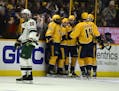 Nashville Predators forward Viktor Arvidsson (33) is congratulated after scoring against the Minnesota Wild in the third period of an NHL hockey game 