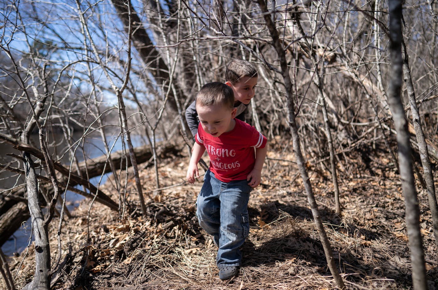 Four-year-old David Peterson and his eight-year-old brother Joshua explore the wooded riverbanks behind their home. ] MARK VANCLEAVE &#xa5; The Rum River is one of six protected under Minnesota' wild and scenic river program, but the city of St. Francis wants the state to loosen its rules for development along its stretch of the Rum. Photographed Tuesday, Apr 16, 2019.