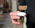 Furniture designer/maker Willie Willette holds a miniature model of a custom walnut chair at his wood shop and studio in Minneapolis in 2018.