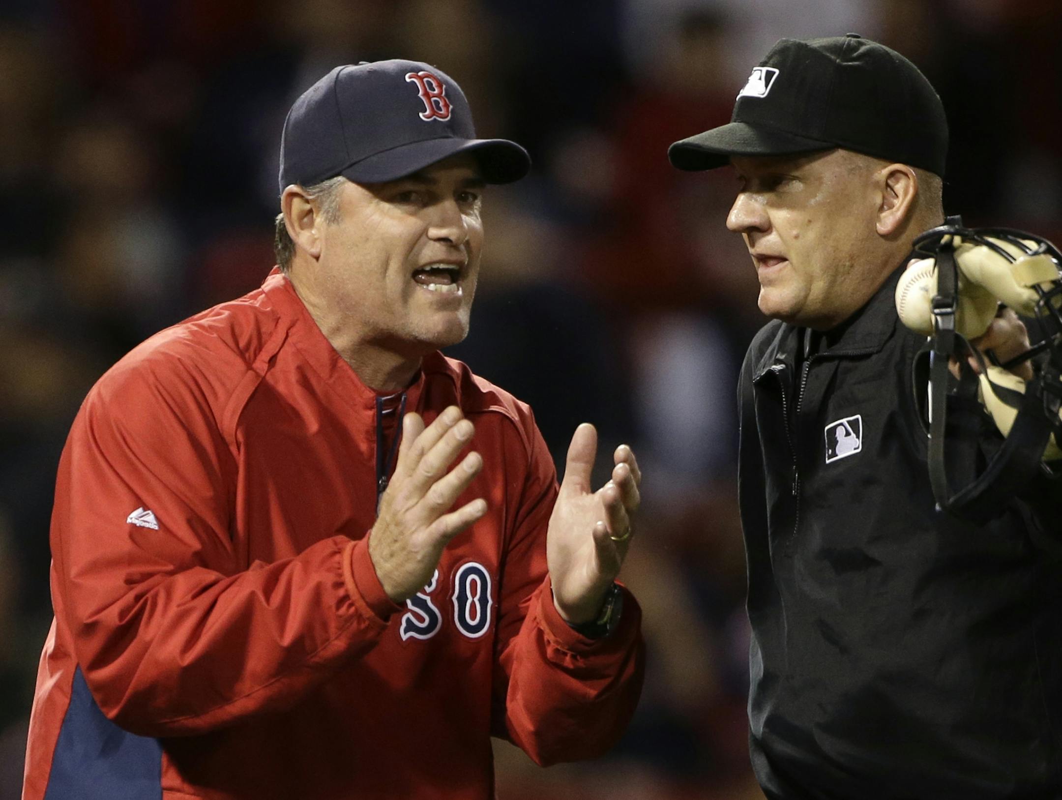 Boston Red Sox manager John Farrell argues with home plate umpire Jeff Nelson during the eighth inning of a baseball game against the Minnesota Twins at Fenway Park in Boston, Tuesday, May 7, 2013.