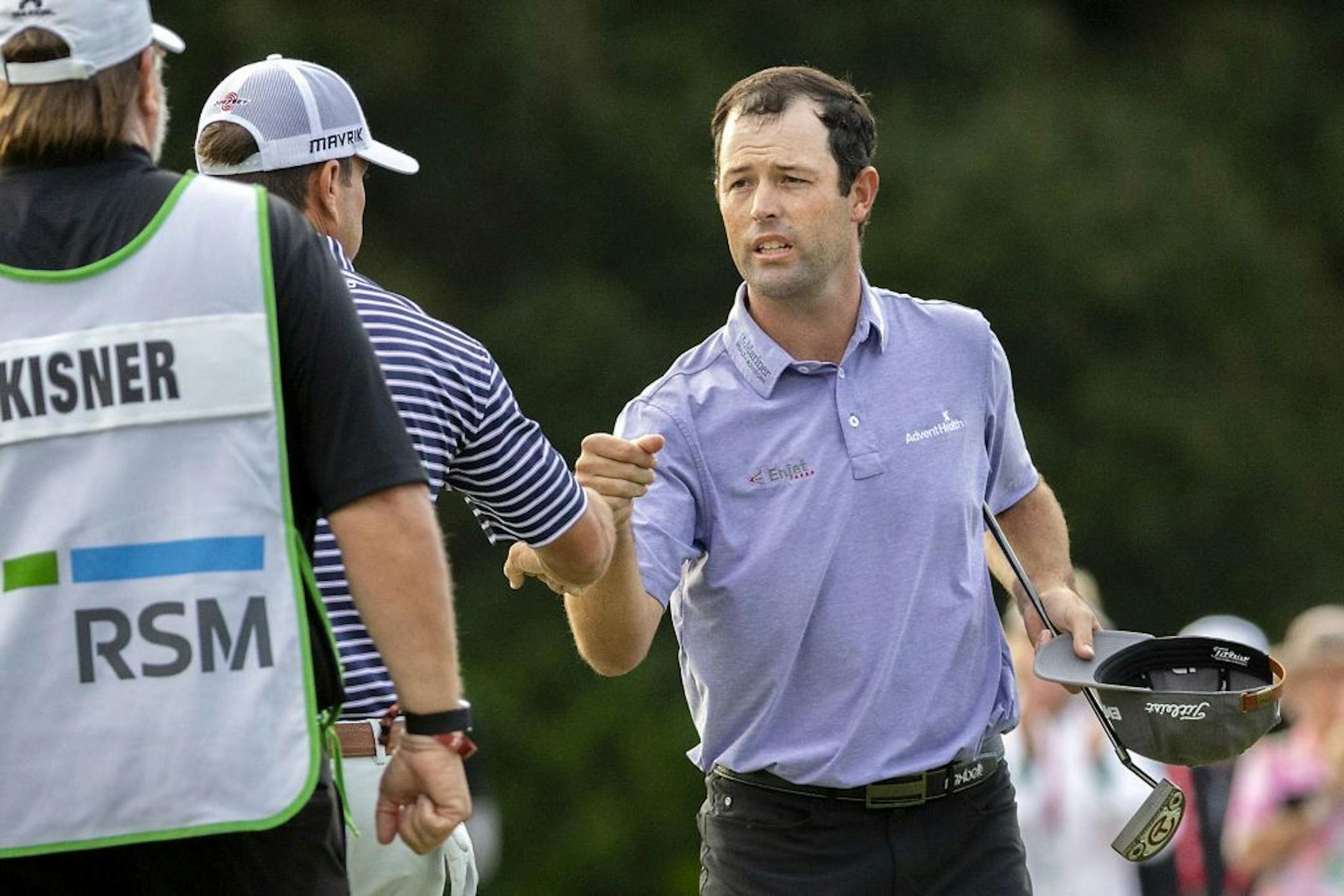 Robert Streb, right, fist-bumps Kevin Kisner after winning a second hole playoff at the RSM Classic golf tournament, Sunday, Nov. 22, 2020, in St. Simons Island, Ga.