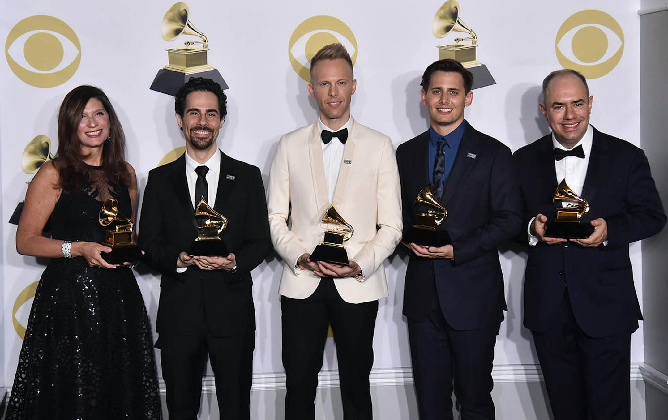 Stacey Mindich, from left, Alex Lacamoire, Justin Paul, Benj Pasek, Pete Ganbarg pose in the press room with the best musical theater album award for "Dear Evan Hansen" at the 60th annual Grammy Awards at Madison Square Garden on Sunday, Jan. 28, 2018, in New York.