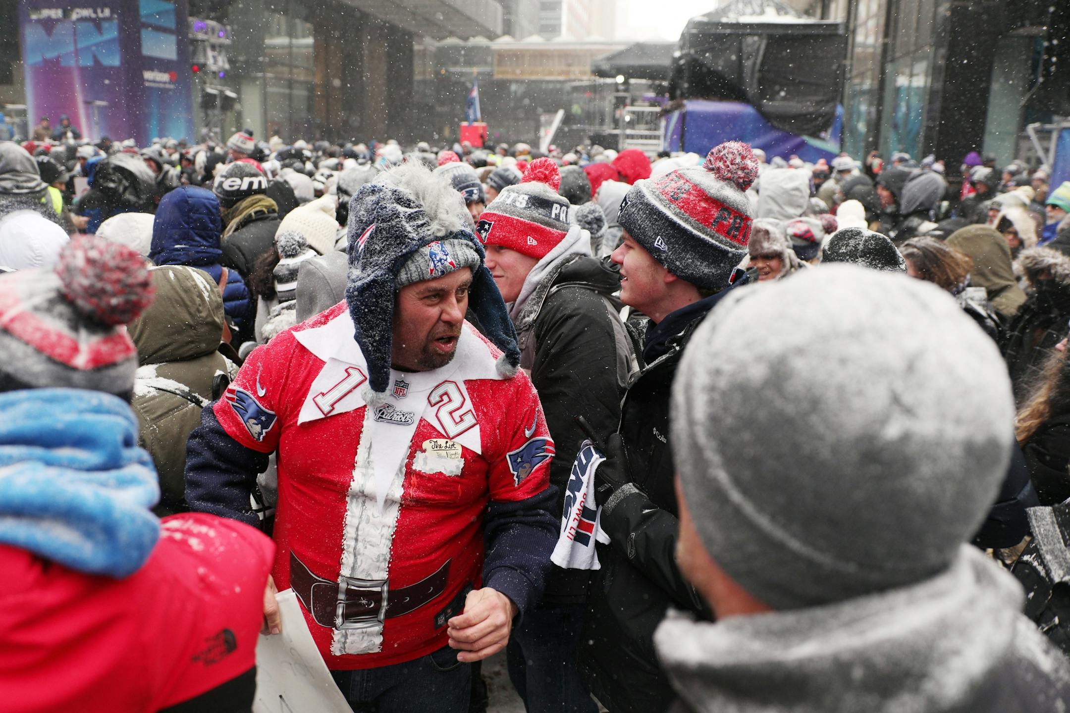 Joe Dewsnap, left, of Fall River, Mass. talked with fellow Patriots fans as he waited for the start of their rally Saturday on Nicollet Mall.