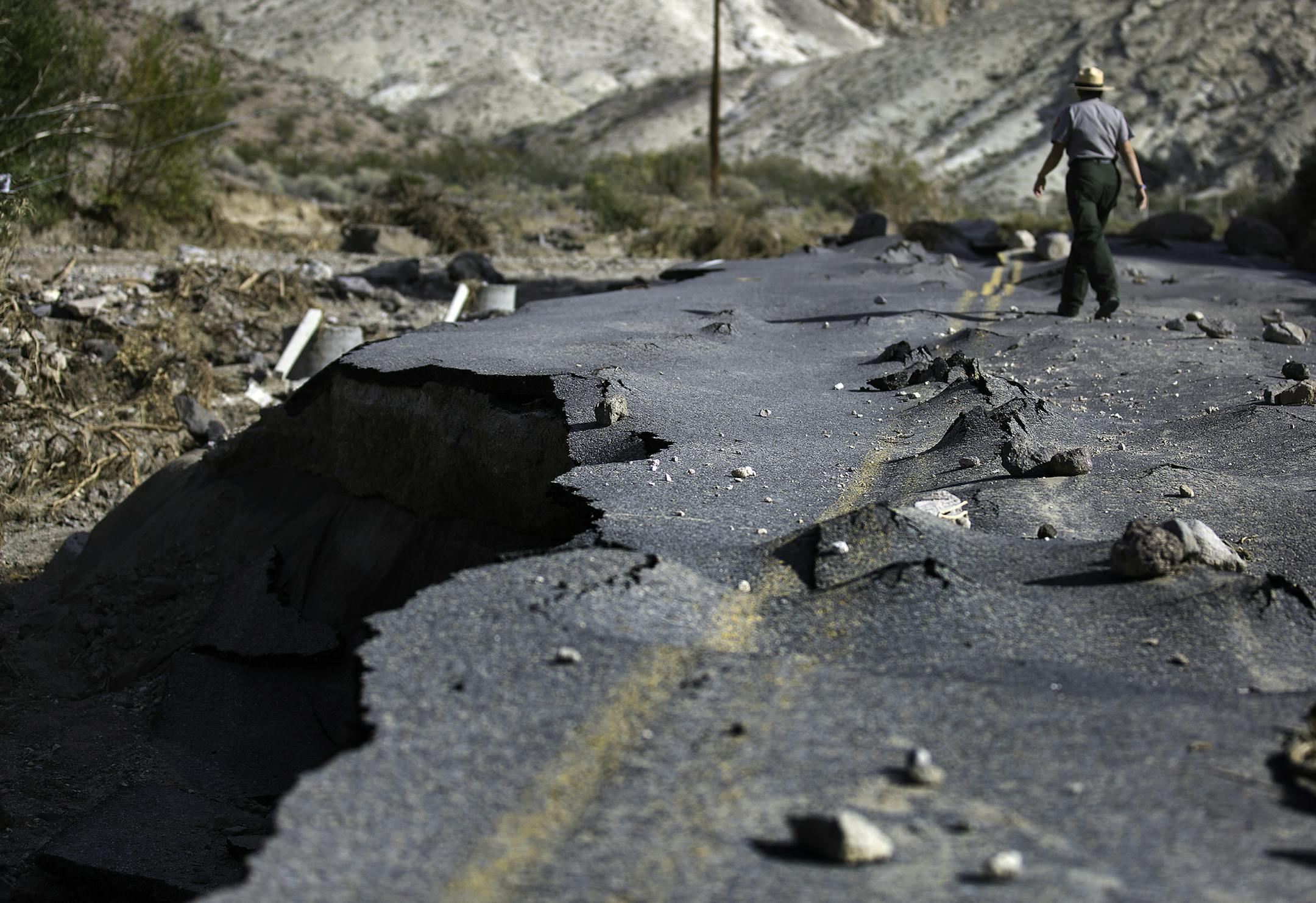 A 100-yard-long section of a newly paved Hwy. 267 in Grapevine Canyon, a two-lane road designed to withstand severe flooding, was lifted up by roiling water, then slammed down on boulders in Death Valley National Park, Calif., on Nov. 2, 2015. (Brian van der Brug/Los Angeles Times/TNS) ORG XMIT: 1176418