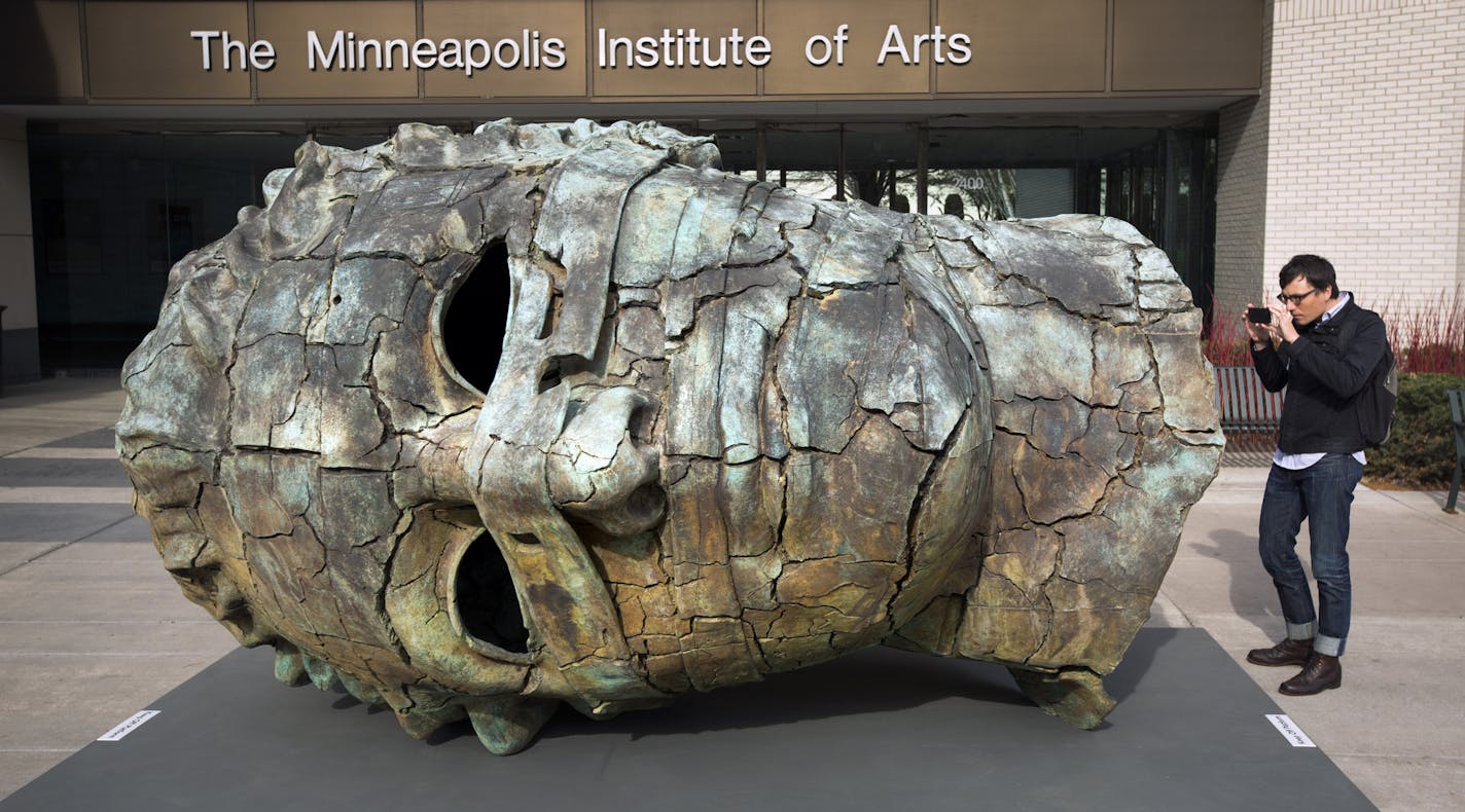 Dylan Thomas took a photo of &#x201c;Eros,&#x201d; a $1 million sculpture by Igor Mitoraj, on display Tuesday outside the 3rd Avenue entrance to the Minneapolis Institute of Arts .