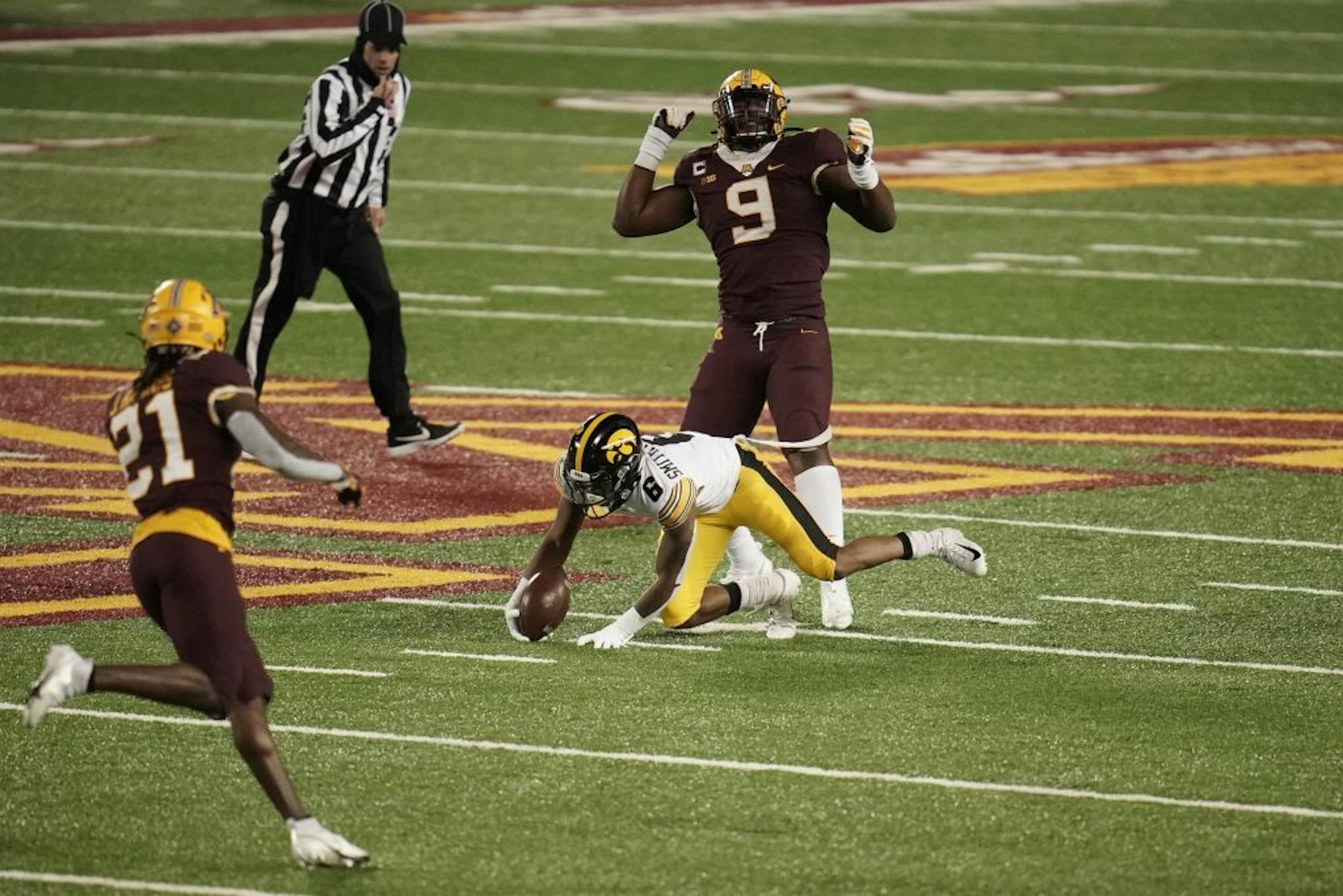 Minnesota Gophers defensive lineman Esezi Otomewo (9) celebrated tackling Iowa Hawkeyes wide receiver Jack Combs (9) in the second quarter.