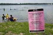 A social distancing sign at Lake Harriet Thursday afternoon. ] aaron.lavinsky@startribune.com The scene at Lake Harriet's South Beach photographed Thu