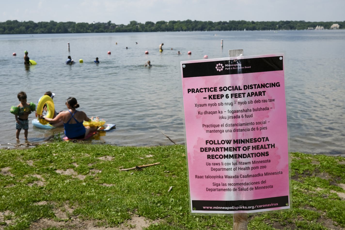 A social distancing sign at Lake Harriet Thursday afternoon. ] aaron.lavinsky@startribune.com The scene at Lake Harriet's South Beach photographed Thursday, July 2, 2020 in Minneapolis, Minn.