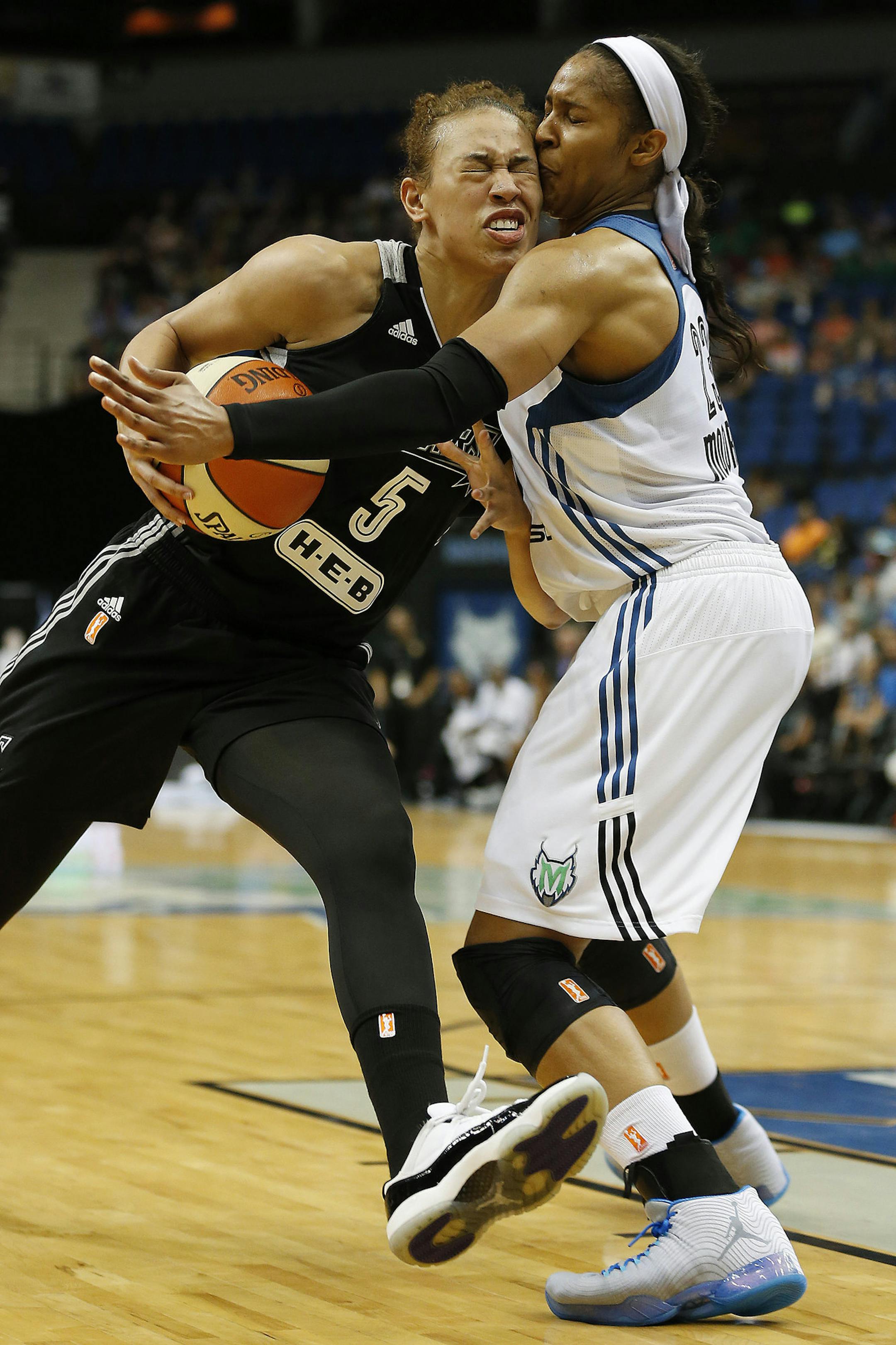 San Antonio Stars guard Dearica Hamby (5) runs into Minnesota Lynx forward Maya Moore, right, during the first half of a WNBA basketball game, Sunday, July 12, 2015, in Minneapolis. (AP Photo/Stacy Bengs)