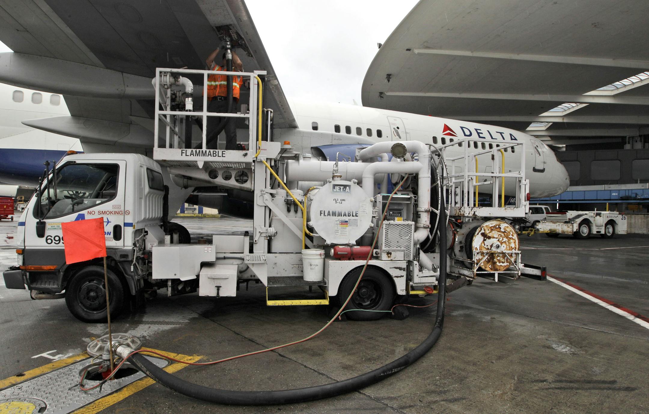 In this Wednesday, Aug. 1 2012 photo, a Delta Air Lines grounds refuels a departing flight at JFK International airport in New York. (AP Photo/Mary Altaffer)