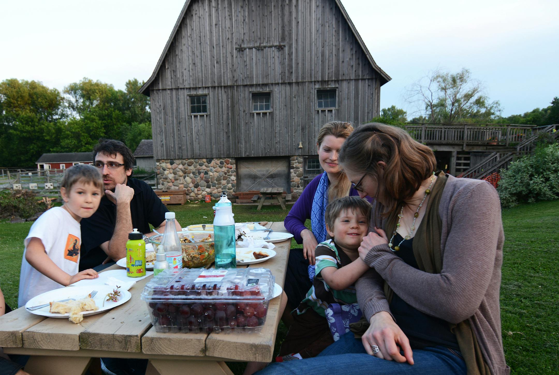 Nils Whelan, 5, of Woodbury, Rafael Cruz, of Barcelona, Faith Whelan, of Minneapolis, Arden Whelan, 3, and Jen Whelan, of Woodbury, picnicked on the grounds of Dodge Nature Center in West St. Paul. They had come to attend the outdoor concert, which was moved indoors due to threat of rain. Photo by Liz Rolfsmeier, Special to the Star Tribune
