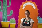Dulce Monterrubio, the owner of Dulceria Bakery, at her Minneapolis bakery cafe in front of a mural painted by her 17-year-old daughter Sofia Haase-Ol