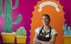 Dulce Monterrubio, the owner of Dulceria Bakery, at her Minneapolis bakery cafe in front of a mural painted by her 17-year-old daughter Sofia Haase-Ol