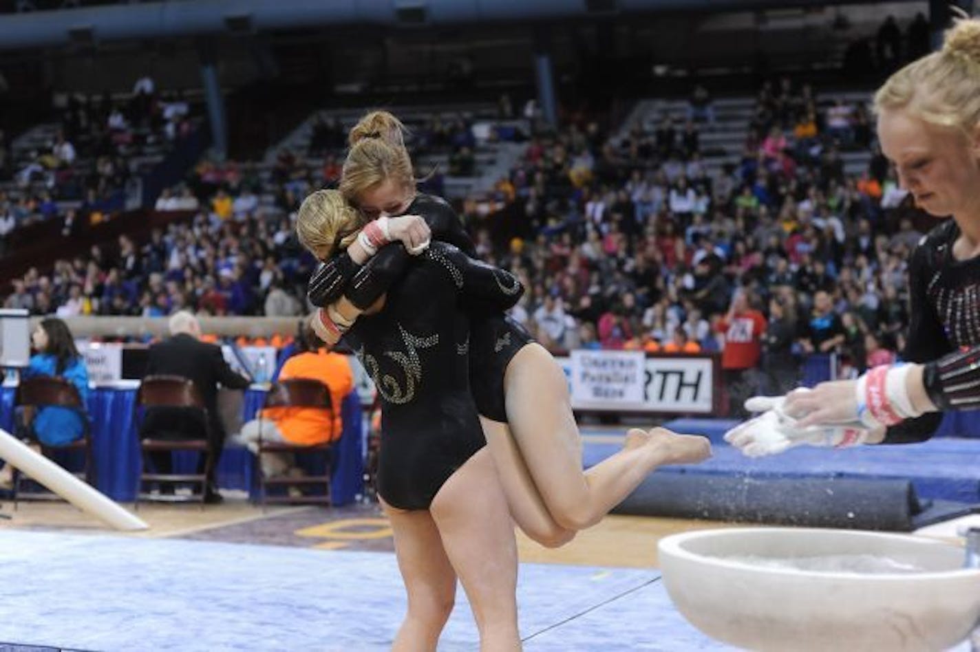 Perham's Carly Petersen congratulated Detroit Lakes' Amy Crawford after her routine on uneven parallel bars during a Class A Individual Minnesota State Gymnastics Tournament on February 26th at the Sports Pavilion in Minneapolis, Minn.