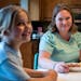 Ellie, 7, eats dinner with her mother, Meta Getman, at their home in Eden Prairie. Getman, a fertility coach, gave birth to Ellie and her twin, Addie,