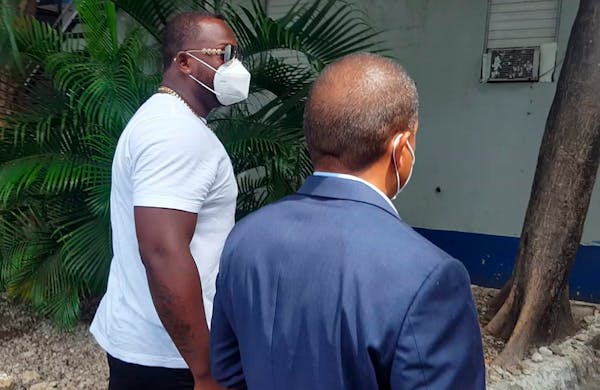 Minnesota Twins slugger Miguel Sano, right, arrives to the Prosecutor's Office accompanied by his lawyer, in his hometown San Pedro de Macoris, Domini