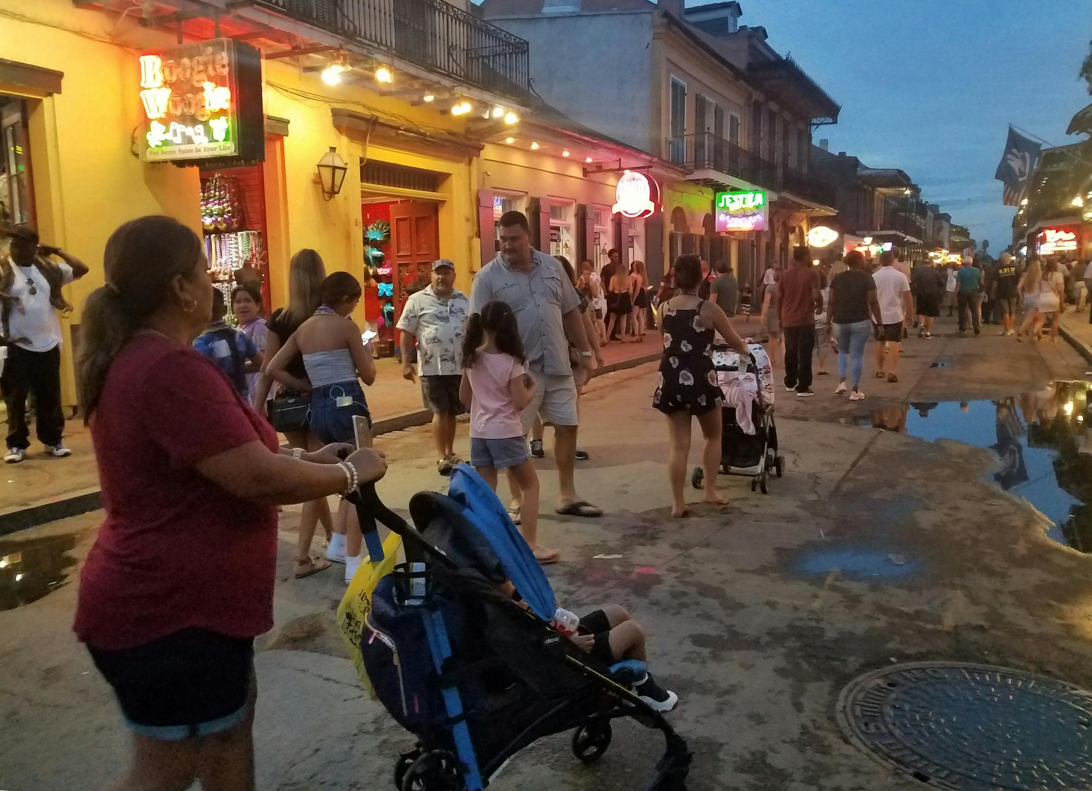 A family walks down Bourbon Street in New Orleans at dusk. (Jenny Jarvie/Los Angeles Times/TNS)