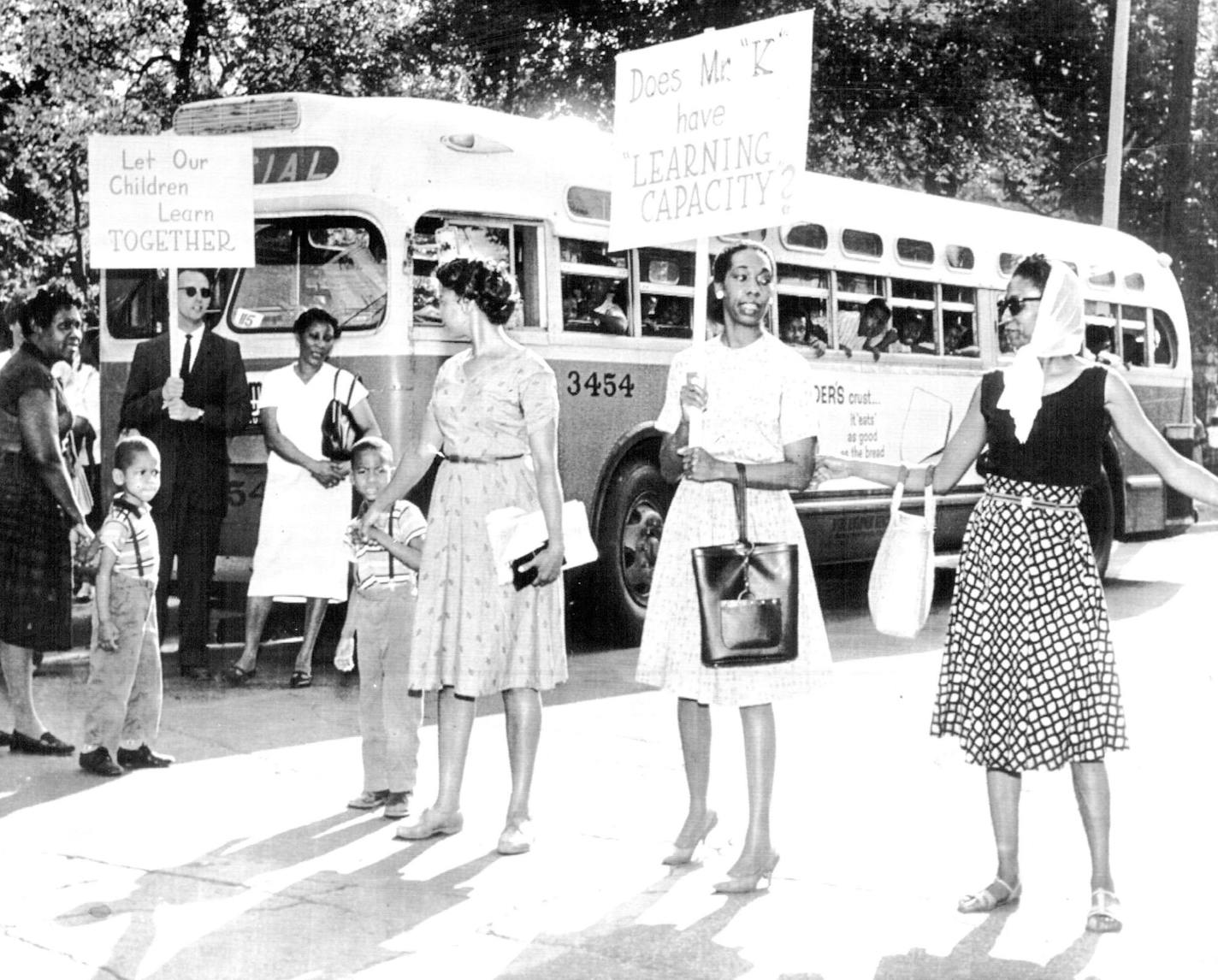 June 8, 1963 Negro Parents Blocked buses that were to take their children to schools in St. Louis Parents said the schools were segregated; several buses were stopped. A human chain of singing, placard-waving Negro parents led by a lone white woman Friday blocked transportation of hundreds of Negro children to public schools where they have been kept apart from classes of predominantly white pupils. Thirty picketing parents and Negro ministers, charging segregation in the school system' s progra