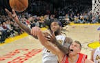 Los Angeles Lakers center Jordan Hill, left, puts up a shot as Houston Rockets center Cole Aldrich defends during the second half of their NBA basketb