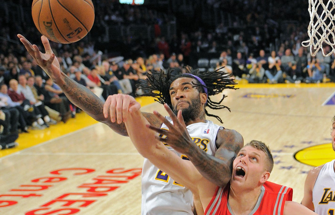 Los Angeles Lakers center Jordan Hill, left, puts up a shot as Houston Rockets center Cole Aldrich defends during the second half of their NBA basketball game, Sunday, Nov. 18, 2012, in Los Angeles. The Lakers won 119-108. (AP Photo/Mark J. Terrill) ORG XMIT: LAS118