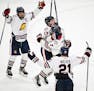 Teammates celebrate with Orono forward Avery Anderson (7) after Anderson scored the game winning goal off a tip against Northfield goaltender Keaton W