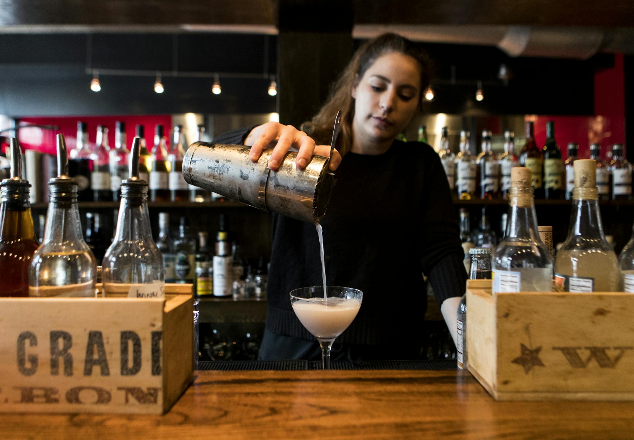 Bartender Katie Masterson, of Providence, pours the speciality cocktail 'El Violeta' at Nicks on Broadway in Providence, Rhode Island, on May 3, 2019. MUST CREDIT: Photo for The Washington Post by Ruby Wallau
