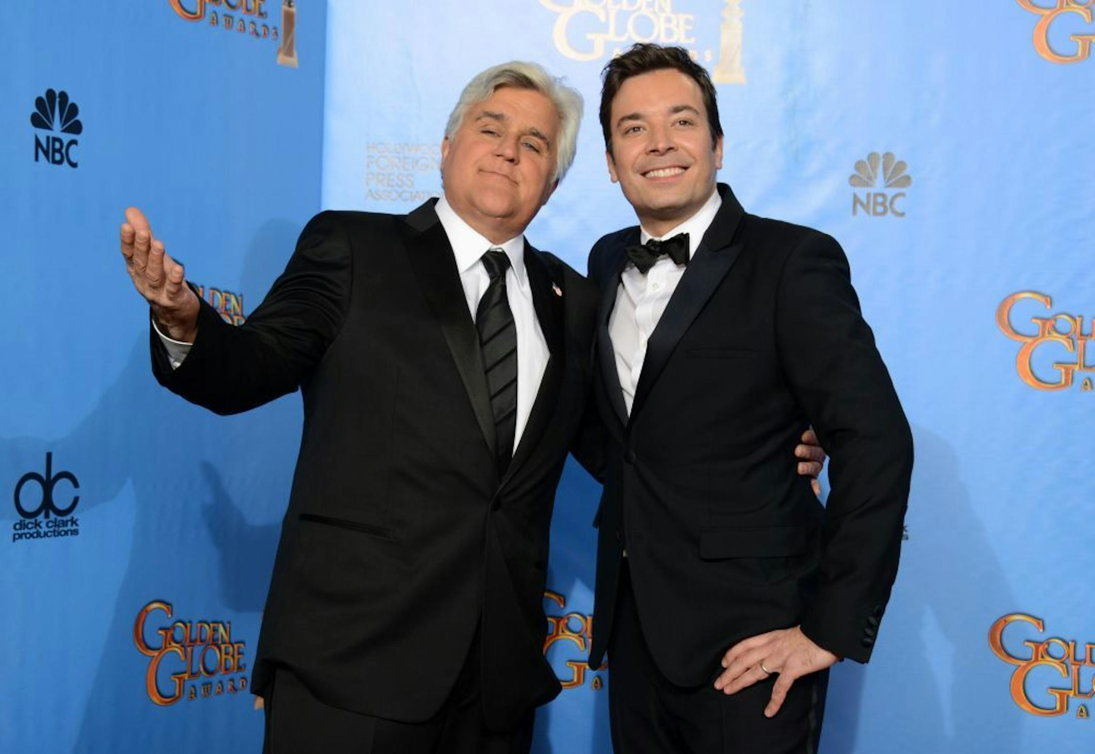 FILE - This Jan. 13, 2013 file photo shows Jay Leno, host of "The Tonight Show with Jay Leno," left, and Jimmy Fallon, host of "Late Night with Jimmy Fallon" backstage at the 70th Annual Golden Globe Awards in Beverly Hills, Calif.