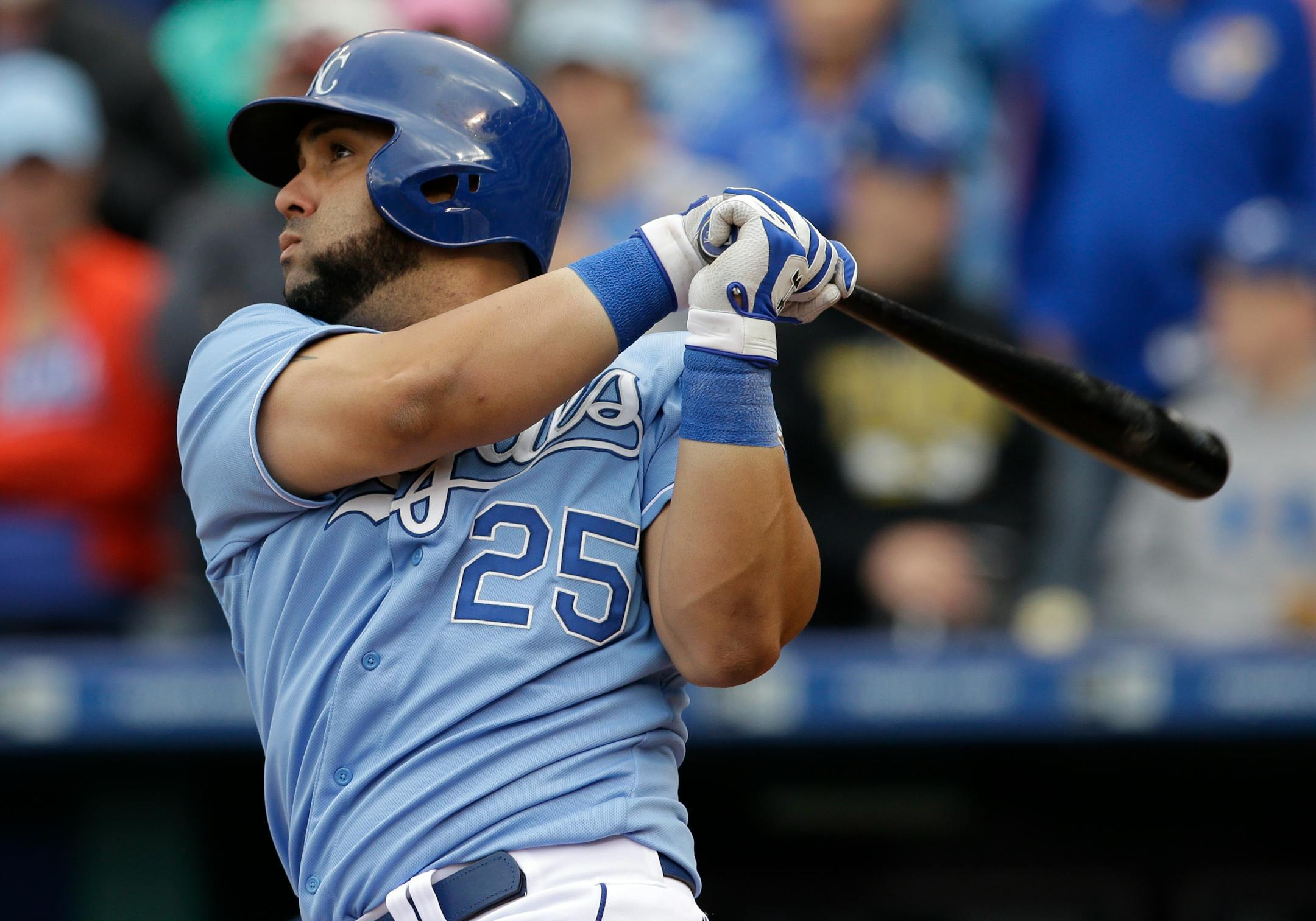 Kansas City Royals designated hitter Kendrys Morales (25) hits a two-run double during the eighth inning of a baseball game against the Oakland Athletics at Kauffman Stadium in Kansas City, Mo., Sunday, April 19, 2015. The Royals defeated the Athletics 4-2. (AP Photo/Orlin Wagner)