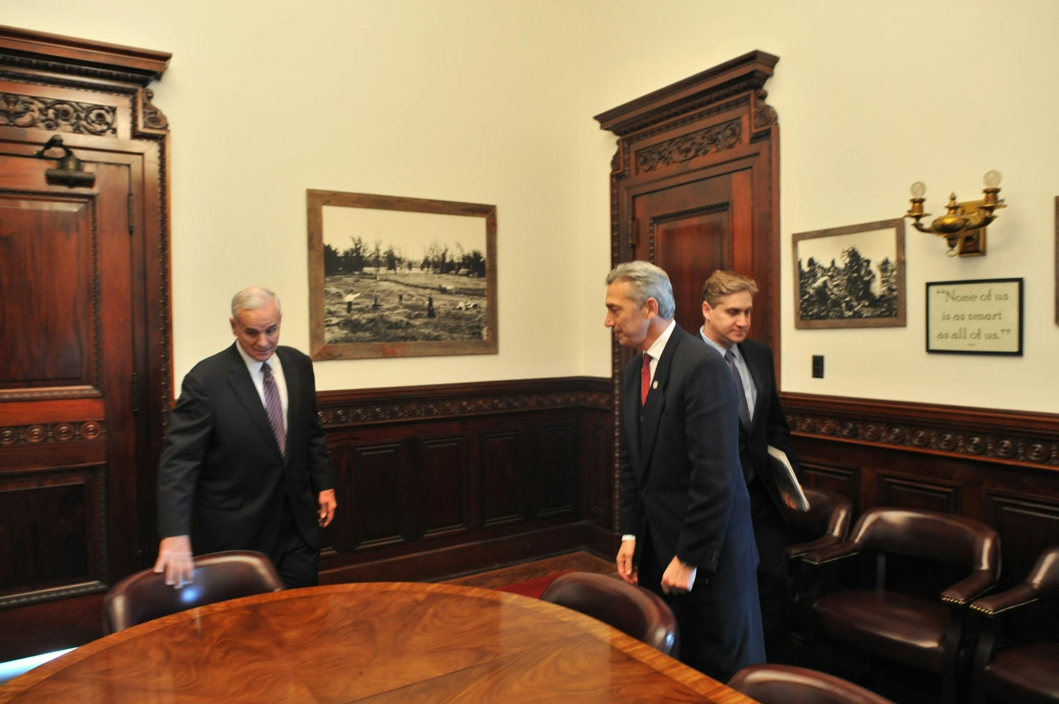 NFL VP Eric Grubman, gray hair at right front, NFL VP Neil Glat at right in back, at the capitol to meet with Gov. Mark Dayton regarding a new stadium for the Vikings.