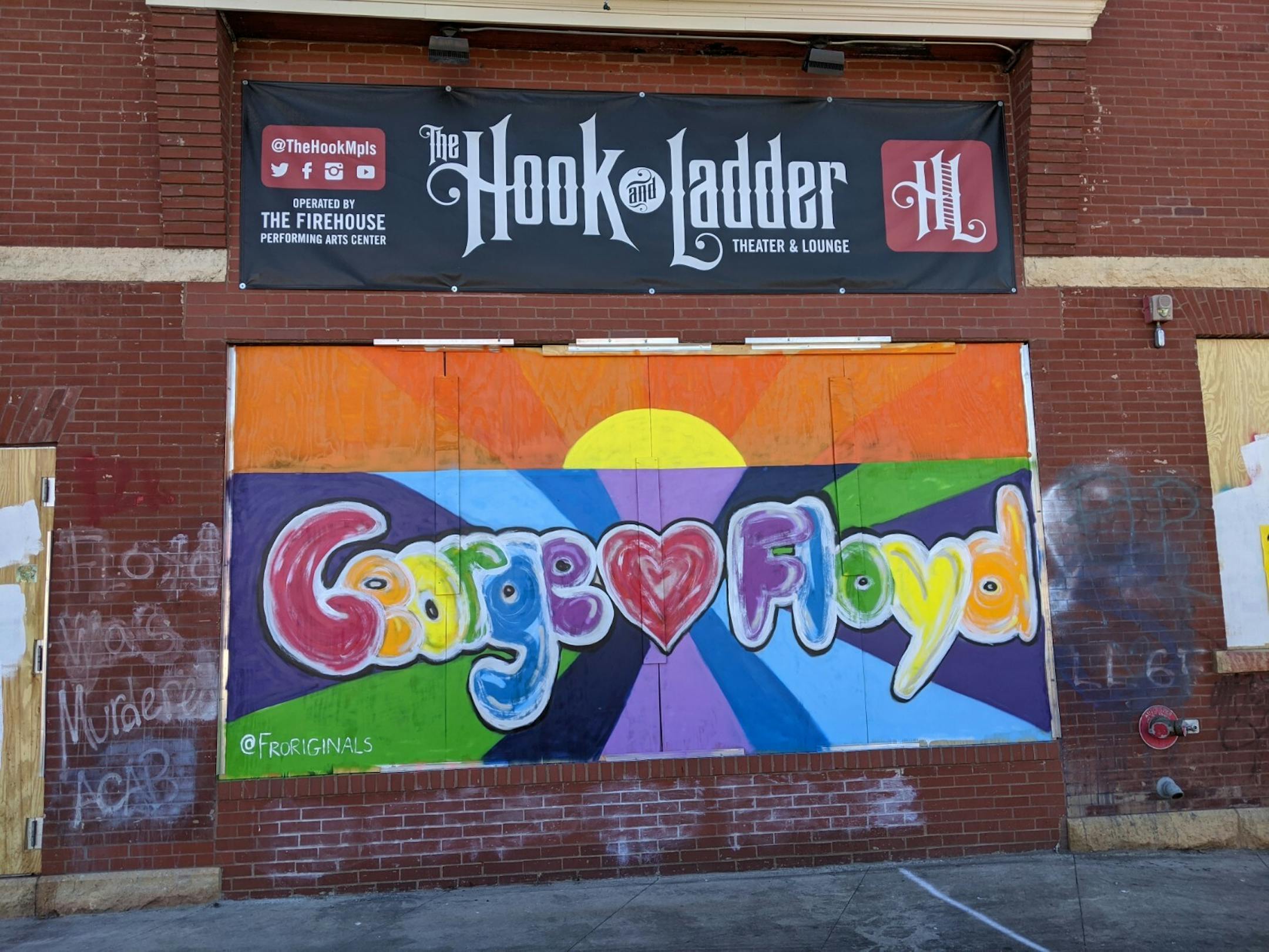 Artist @froriginals' heartwarming mural of Floyd's name spelled out in rainbow letters is located across the street from Minnehaha Lake Wine & Spirits, which was destroyed by fire following protests over the death of George Floyd in police custody that turned violent.