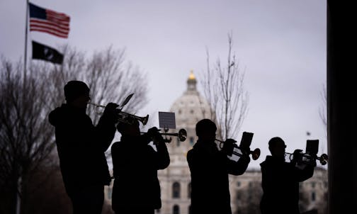 An ensemble of trumpets, who are also veterans, play America the Beautiful at the conclusion of the program on the grounds of the State Capitol in St. Paul on Veterans Day. Bells tolled across Minnesota on Friday, November 11 at 11 a.m., including the Minnesota Liberty Bell located on the campus of the State Capitol.