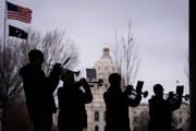 An ensemble of trumpets, who are also veterans, play America the Beautiful at the conclusion of the program on the grounds of the State Capitol in St.