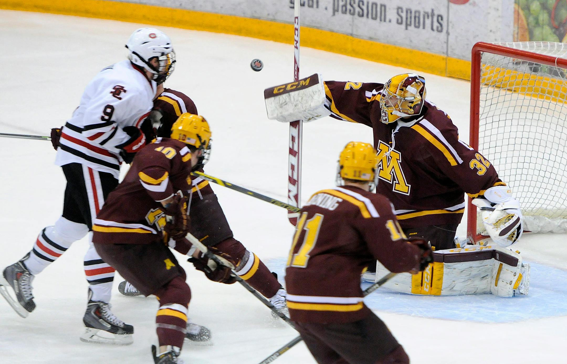 The puck goes high on Minnesota goaltender Adam Wilcox during the first period of a college hockey game against St. Cloud State on Friday, Oct. 31, 2014, in St. Cloud, Minn. (AP Photo/The St. Cloud Times, Dave Schwarz)