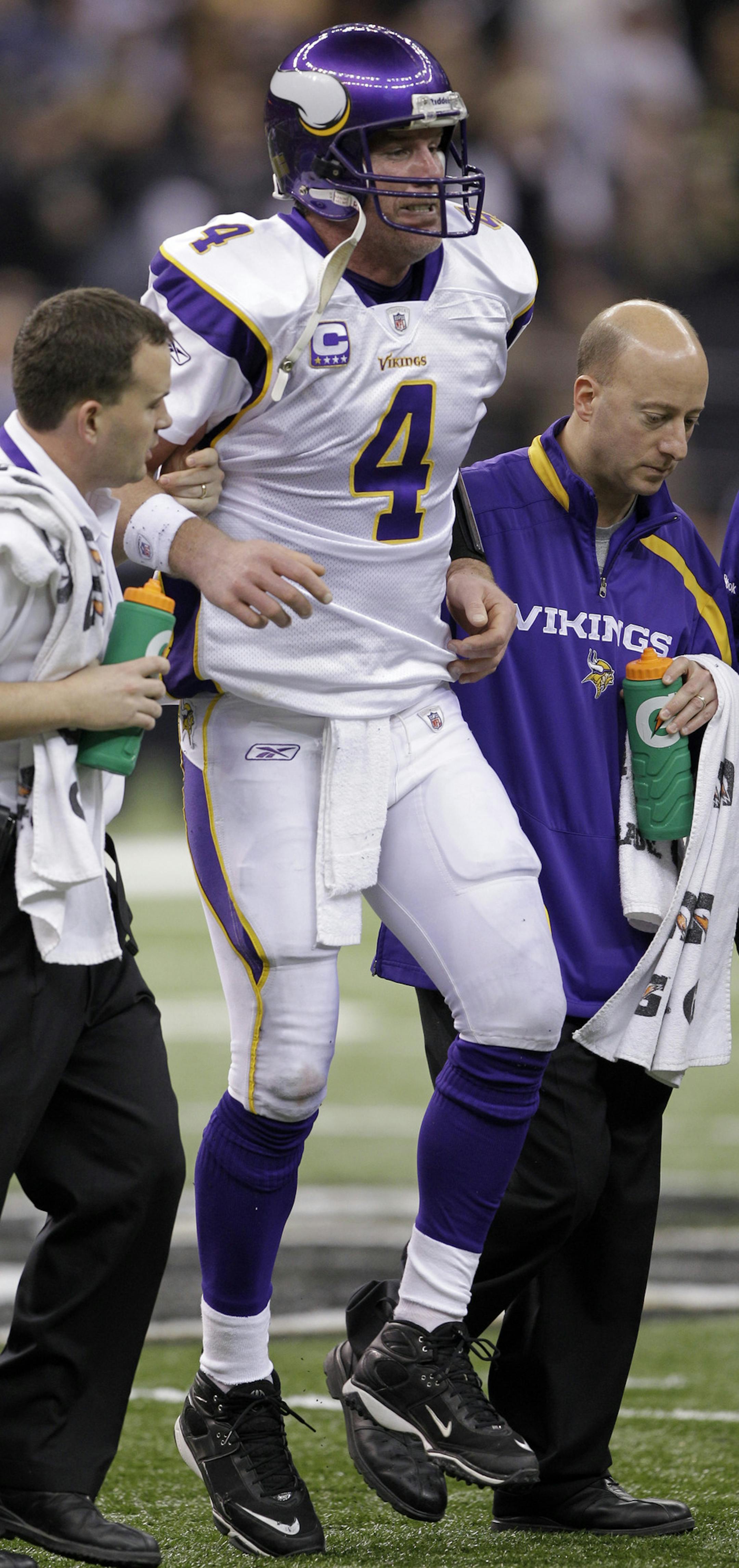 FILE - This Jan. 24, 2010, file photo shows Minnesota Vikings quarterback Brett Favre being helped off the field after being hit during the third quarter of the NFC Championship NFL football game against the New Orleans Saints, in New Orleans. The NFL says that New Orleans Saints players maintained a bounty program over the last three seasons that targeted opponents with the intent to injure them. The league disclosed the findings of an investigation Friday, saying between 22 and 27 defensive pl