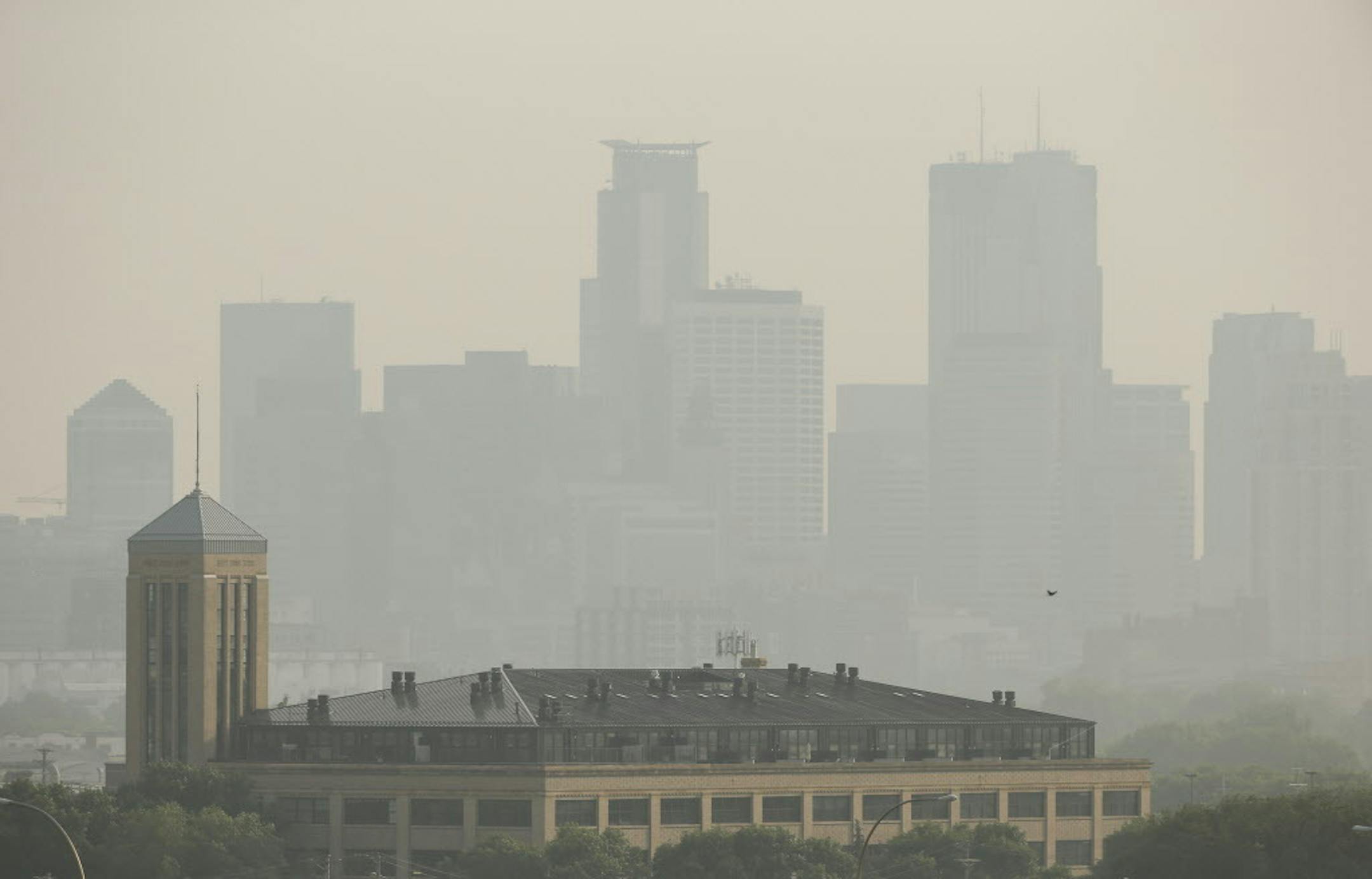 A haze rest along the Minneapolis skyline from the view of Ridgeway Parkway Park, Monday, July 6, 2015, in Minneapolis. The Minnesota Pollution Control Agency is expand its air pollution warning due to smoke from wildfires in Canada. The expanded area includes the Twin Cities. (Jeff Wheeler/Star Tribune via AP) MANDATORY CREDIT; ST. PAUL PIONEER PRESS OUT; MAGS OUT; TWIN CITIES LOCAL TELEVISION OUT