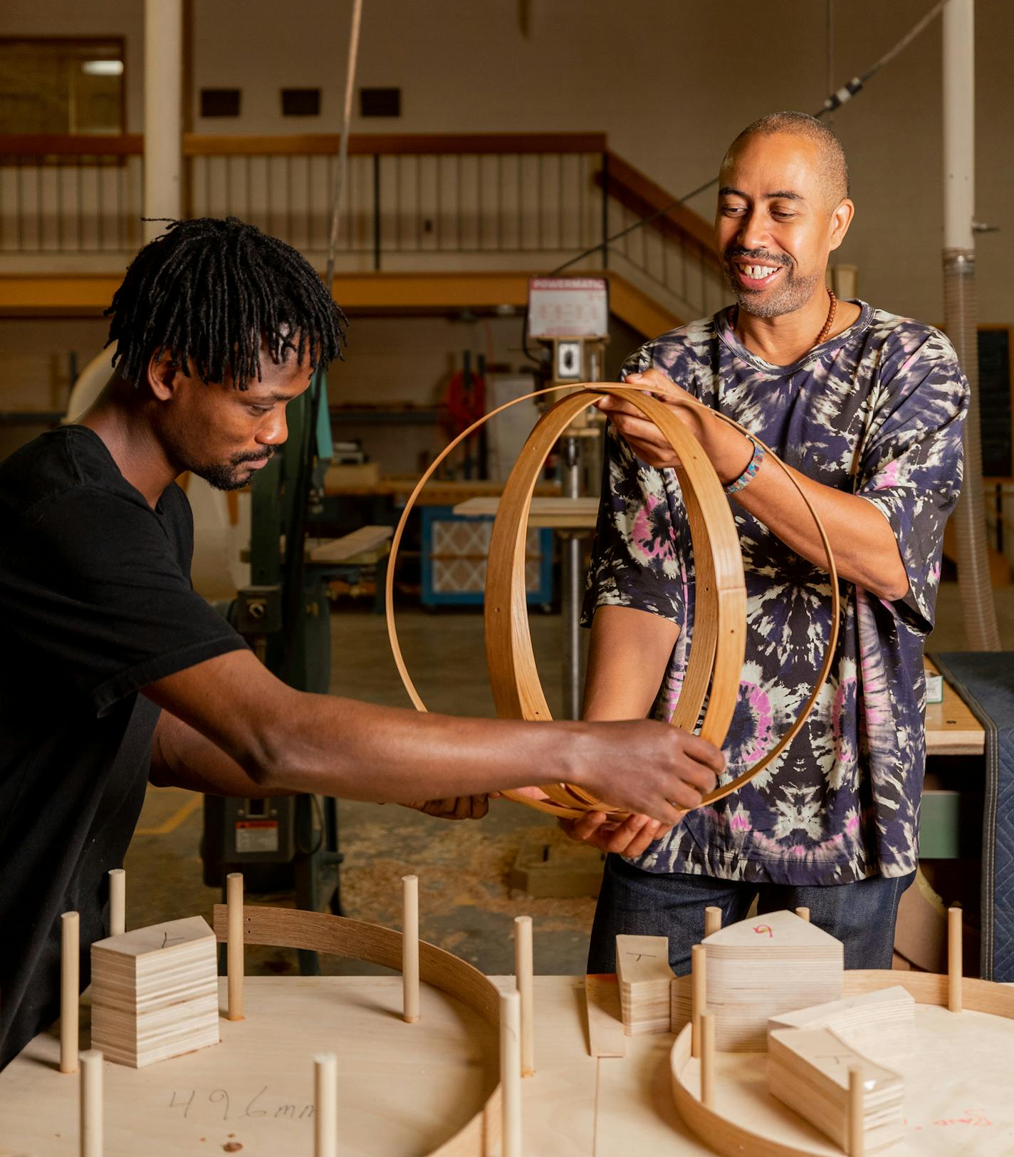 In an undated image provided by Justin Skeens/Berea College Student Craft, the designer Stephen Burks, right, works with Joseph Opaleye, a student in the Crafting Diversity program at Berea College in Kentucky. A tiny proportion of designers are Black, but a host of new initiatives, as well as evolving tastes, are working to right the imbalance. (Justin Skeens/Berea College Student Craft via The New York Times) -- NO SALES; FOR EDITORIAL USE ONLY WITH NYT STORY DESIGN DIVERSITY BY STEPHEN WALLIS